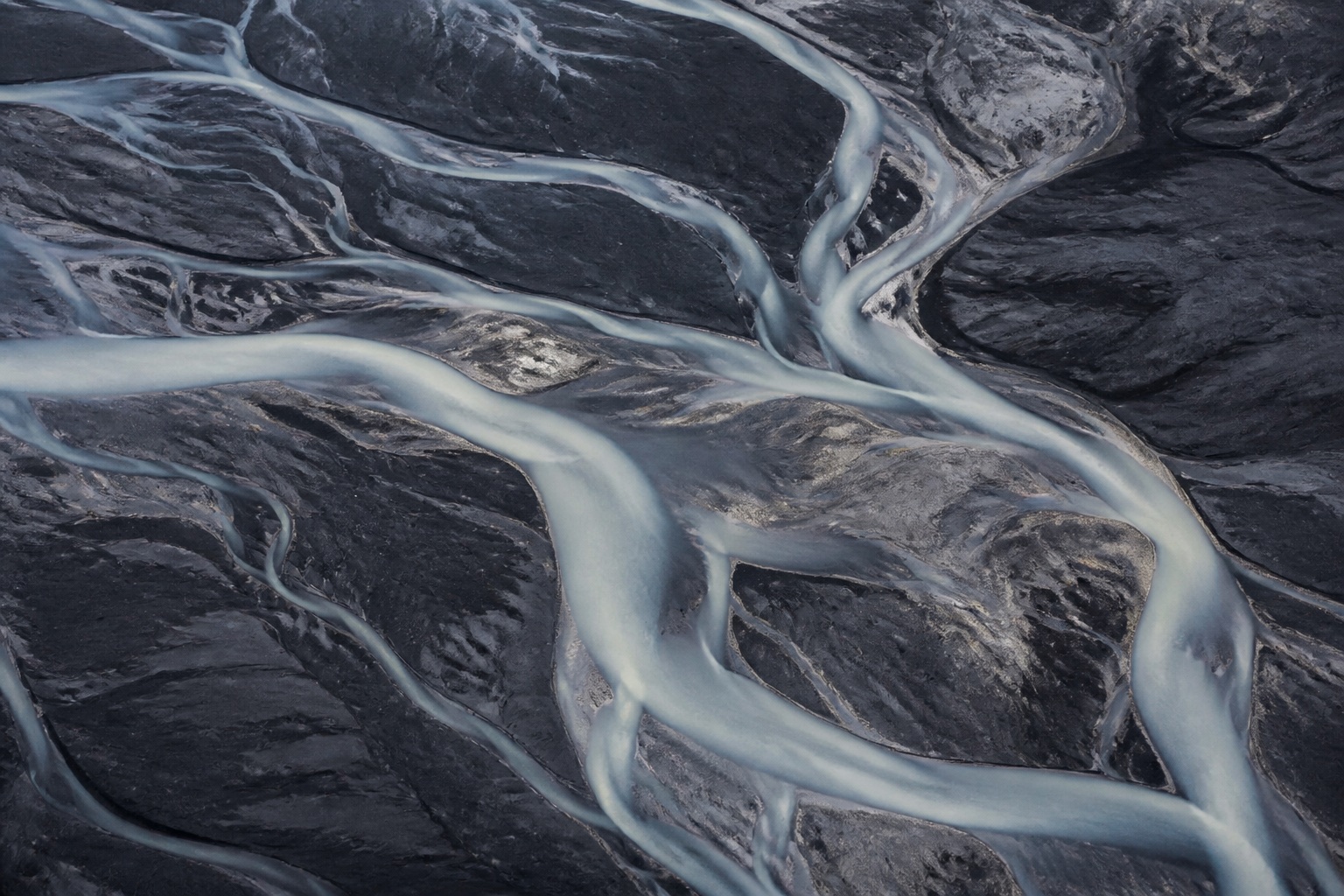 Pale tidal channels crossing a dark shoreline